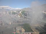 Tibet Lhasa 02 14 Jokhang Roof View to Barkhor Square and Potala Because it was the Dalai Lamas birthday, the juniper leaves were burning especially heavy, sending tons of smoke to the Jokhang roof and on to the heavens. From the Jokhang's roof, we looked down at Barkhor Square and the Jowo Utra (Hair of the Buddha), a recently built stone enclosure with a willow tree and two 3m tall steles.